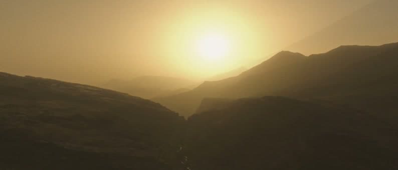 Sunlight breaks over a mountain valley in Morocco at dawn — a still from the film